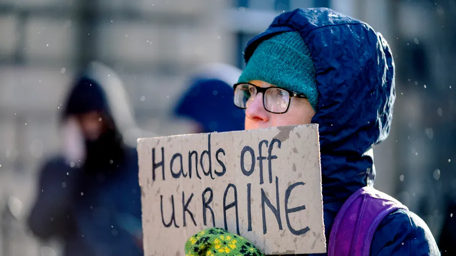 People take part in "Stand with Ukraine" public demonstration outside the Russian Consulate General, following the Russian attack of Ukraine, in Edinburgh, Thursday, Feb. 24, 2022. ((Jane Barlow/PA via AP))