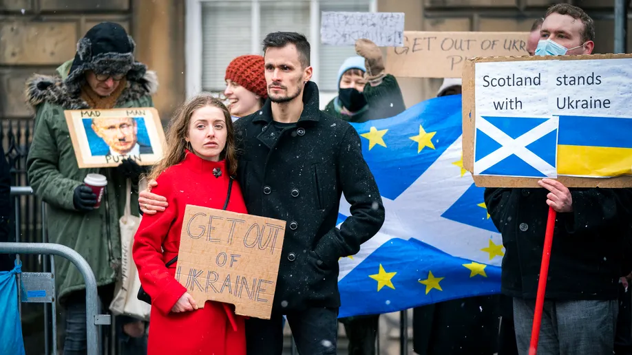People take part in "Stand with Ukraine" public demonstration outside the Russian Consulate General, following the Russian attack of Ukraine, in Edinburgh, Thursday, Feb. 24, 2022. ((Jane Barlow/PA via AP))