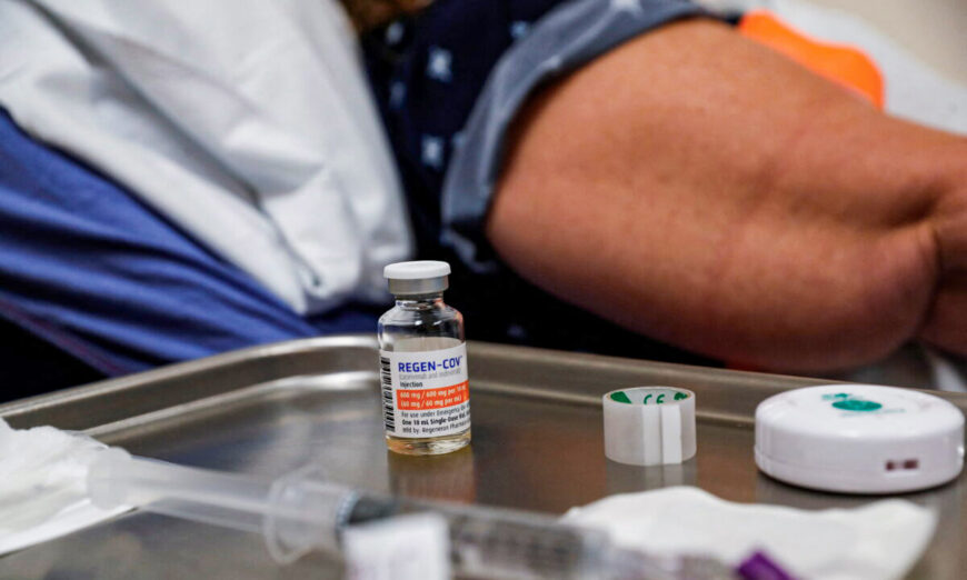 A vial of Regeneron's monoclonal antibody treatment sits on a medical table next to a patient at the Sarasota Memorial Urgent Care Center in Sarasota, Fla., on Sept. 23, 2021. (Shannon Stapleton/Reuters)