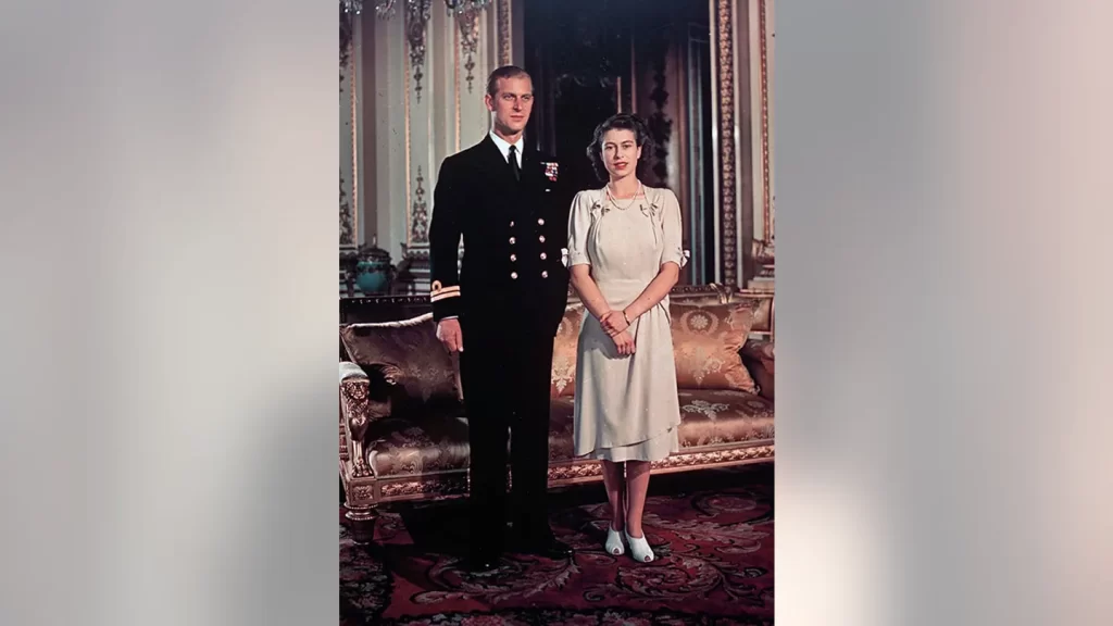FILE - Britain's Princess Elizabeth in a light-colored dress with sleeves above the elbow and peekaboo low heels, appears with Lt. Philip Mountbatten for a photo in London in September 1947. (AP)