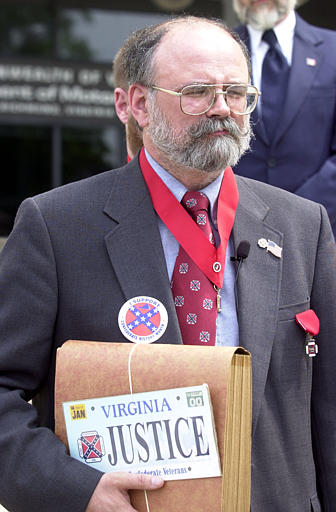 The Supreme Court ruled in Walker v. Sons of Confederate Veterans (2015), that the state of specialty license plates program was a form of government speech. In this photo, Henry E. Kidd, state commander of the Sons of Confederate Veterans, is seen during a news conference on the steps of the Commonwealth of Virginia's Department of Motor Vehicles in Richmond, Virgina, May 2, 2002, to discuss a proposed Confederate license plate. Kidd is holding a sample plate. (AP Photo/Mark Gormus, used with permission from the Associated Press)