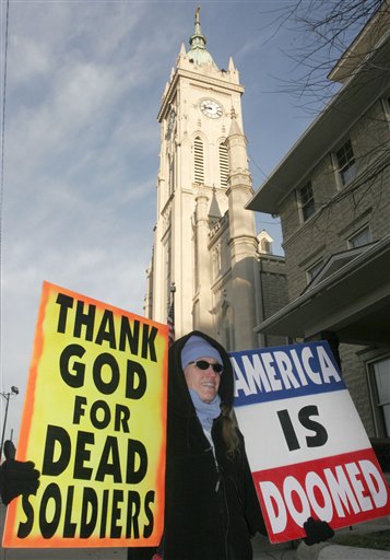 The Kansas-based Westboro Baptist Church regularly picketed military funerals to advance their views that God was punishing the United States for its toleration of homosexuality. The family of a slain Marine sued after church members picketed their son's funeral and was awarded a total of $5 million in damages. The Supreme Court, however, upheld the church's First Amendment free-speech rights. In this 2006 photo, Westboro Baptist Church member Shirley Phelps-Roper holds signs in front of the St. Julie Billiart Catholic Church before a funeral for Army Pfc. Adam Shepherd in Hamilton, Ohio. (AP Photo/David Kohl, used with permission from the Associated Press)