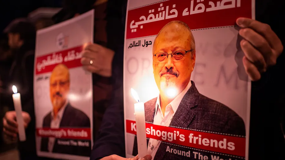 People hold posters picturing Saudi journalist Jamal Khashoggi and lightened candles during a gathering outside the Saudi Arabia consulate in Istanbul, on Oct. 25, 2018. Khashoggi, a Washington Post contributor, was killed on Oct. 2, 2018 after a visit to the Saudi consulate in Istanbul to obtain paperwork before marrying his Turkish fiancée. (YASIN AKGUL/AFP via Getty Images)