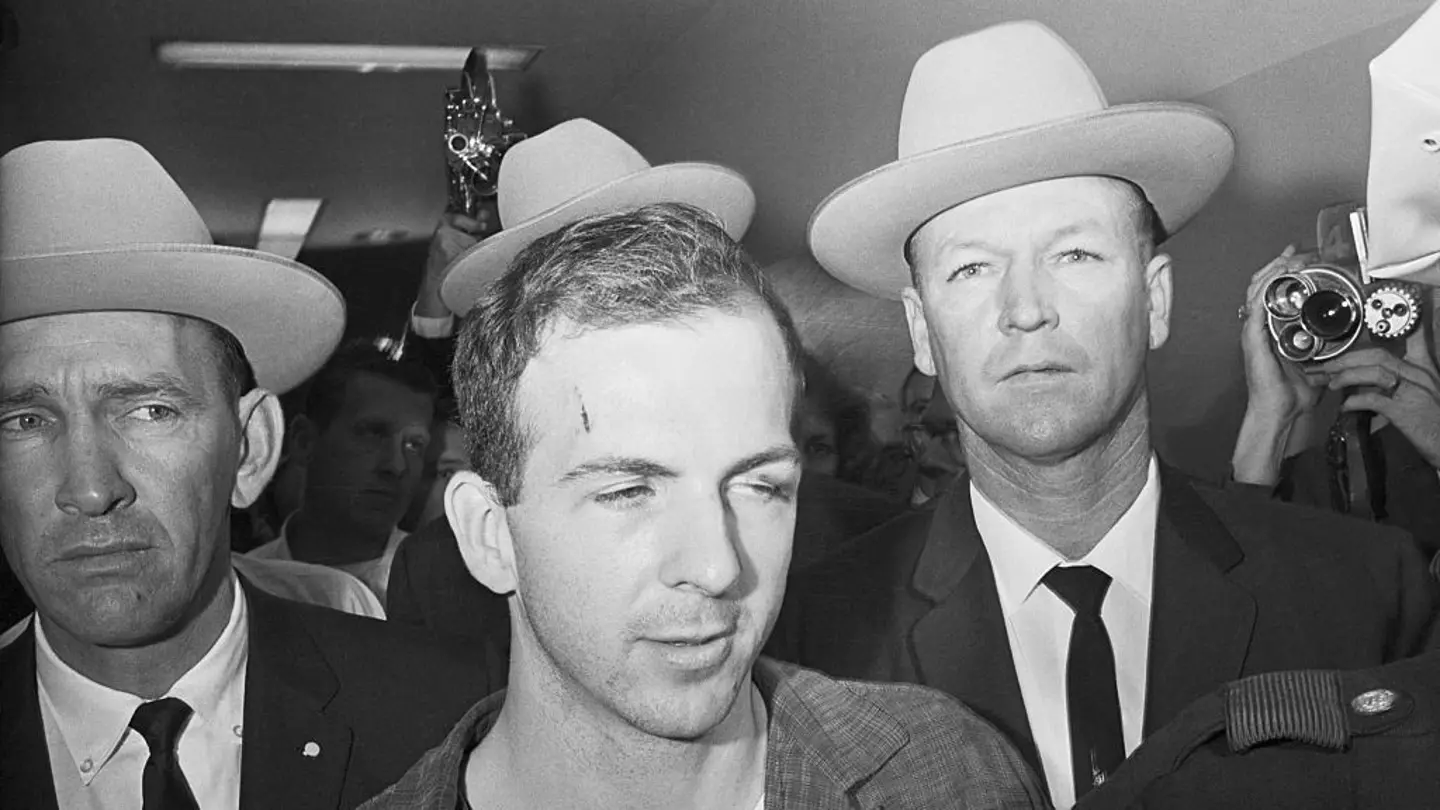 Texas Rangers escort accused Kennedy assassin Lee Harvey Oswald into a Dallas police facility. (Getty Images)