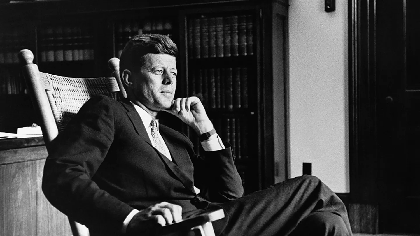 President John F. Kennedy (1917-1963), the 35th president of the United States, relaxes in his trademark rocking chair in the Oval Office. (Getty Images)