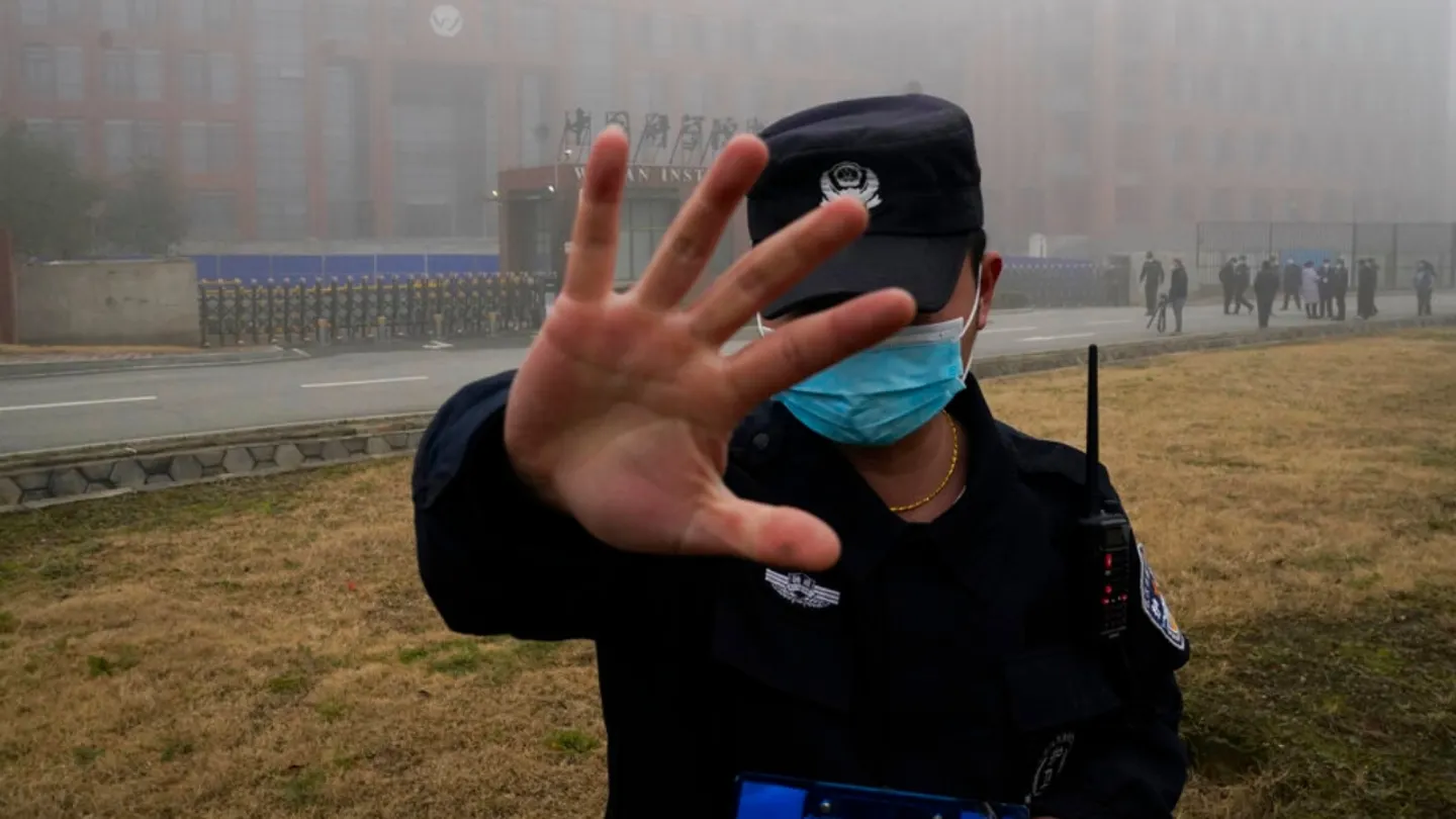 A security person moves journalists away from the Wuhan Institute of Virology. (AP Photo/Ng Han Guan, File)