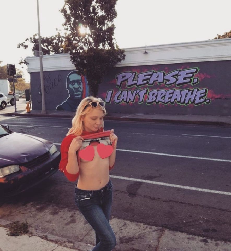 Dakota Skye posing in front of a George Floyd mural