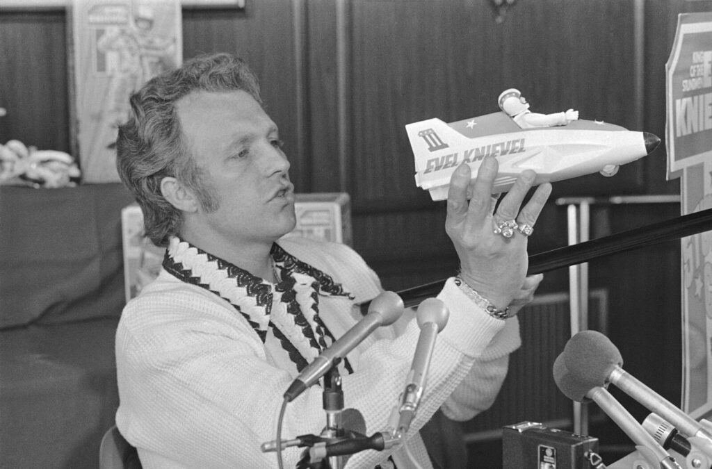 FILE - In this Sept. 3, 1974, file photo, Evel Knievel talks about his upcoming Snake River canyon, Idaho, jump during a news conference in New York. (AP Photo, File)