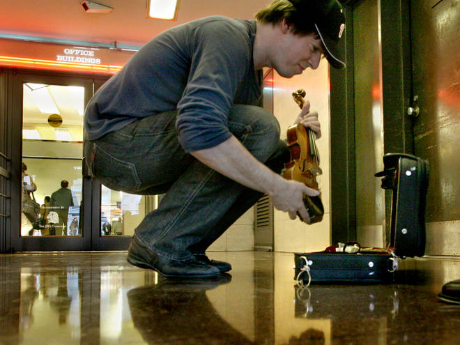 Joshua Bell sets up his violin at L'Enfant Plaza Metro, in Washington, DC. Picture: Michael Williamson/The Washington Post via Getty Images