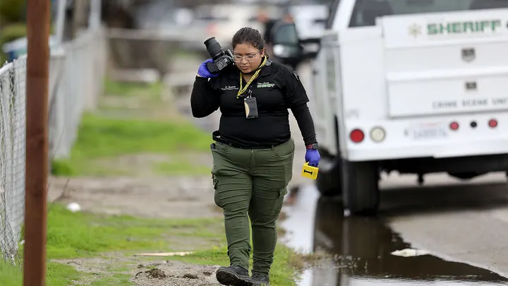 GOSHEN, CA - JANUARY 16: Tulare County Sheriff crime unit investigates the scene where six people, including a 6-month-old baby, her teenage mother and an elderly woman, were killed in a Central Valley farming community in what the local sheriff said was likely a targeted attack by a drug cartel on Monday, Jan. 16, 2023 in Goshen, CA. The massacre occurred around 3:30 a.m. in and around a residence in the Tulare County town of Goshen near Visalia. (Gary Coronado / Los Angeles Times via Getty Images) (Gary Coronado / Los Angeles Times via Getty Images)