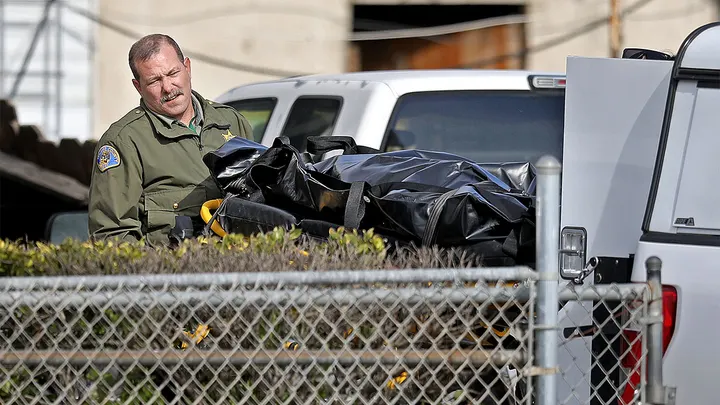 GOSHEN, CA - JANUARY 16: Tulare County Sheriff crime unit removes the body of one of the victims at the scene where six people, including a 6-month-old baby, her teenage mother and an elderly woman, were killed in a Central Valley farming community in what the local sheriff said was likely a targeted attack by a drug cartel on Monday, Jan. 16, 2023 in Goshen, CA. The massacre occurred around 3:30 a.m. in and around a residence in the Tulare County town of Goshen near Visalia. (Gary Coronado / Los Angeles Times via Getty Images) (Gary Coronado / Los Angeles Times via Getty Images)