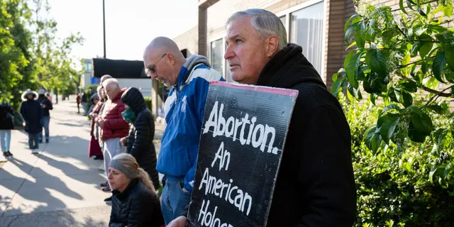  A pro-life demonstrator stands with his sign in front of EMW Women's Surgical Center, an abortion clinic, on May 8, 2021 in Louisville, Kentucky. ((Photo by Jon Cherry/Getty Images))