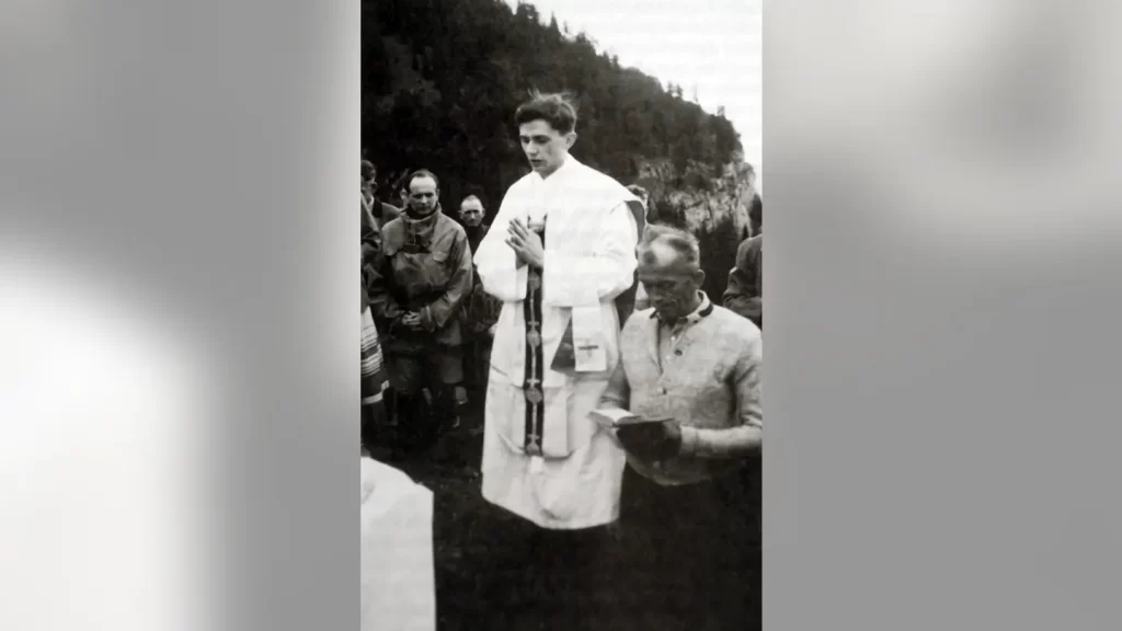 A photo taken during the summer 1952 near Ruhpolding, shows German priest Joseph Ratzinger (C) praying during an open-air mass. (AFP via Getty Images)