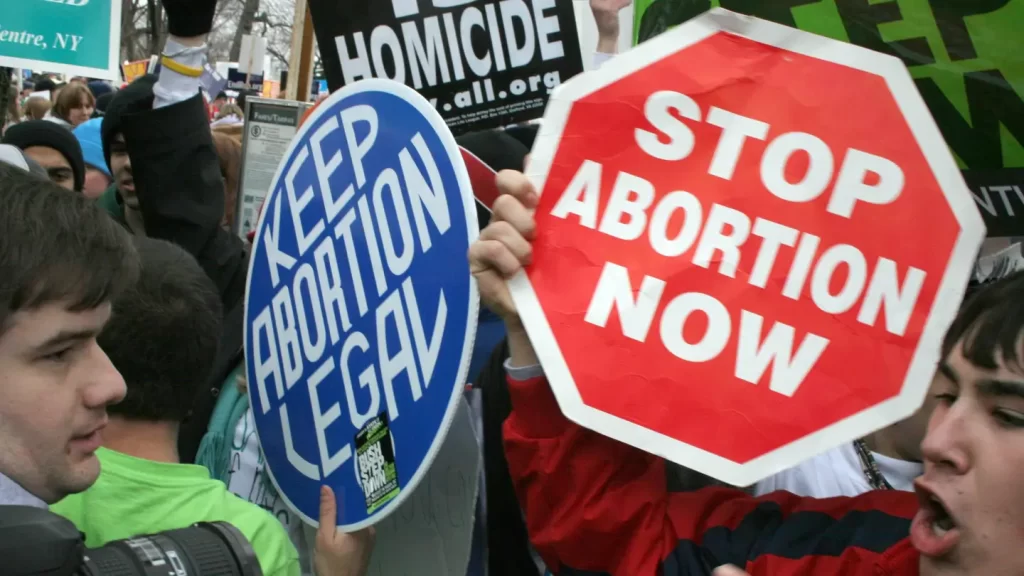 Pro-life demonstrators (R) confront pro-choice counterparts (L) 23 January 2006 in Washington, DC, as tens of thousands of pro-life and pro-choice opponents rally marking the 33rd anniversary of the Supreme Court ruling on abortion. (KAREN BLEIER/AFP via Getty Images)