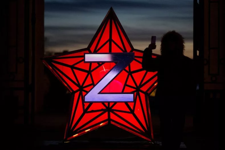 A passer-by takes a photograph of a decoration stylized as the "Kremlin Star", bearing a Z letter, a tactical insignia of Russian troops in Ukraine, in Moscow, Russia on January 2, 2023. North Korea had already officially recognized the independence of Moscow's puppet republics in Donetsk and Luhansk.NATALIA KOLESNIKOVA/AFP VIA GETTY IMAGES
