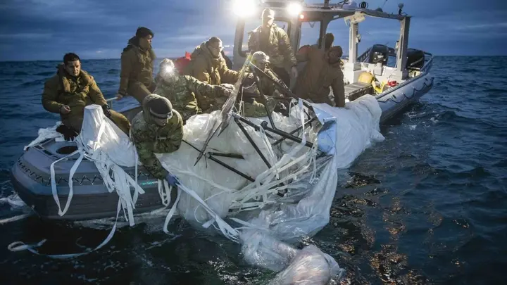 U.S. forces haul debris from China's surveillance balloon onto a boat off the coast of South Carolina. (U.S. Fleet Forces)