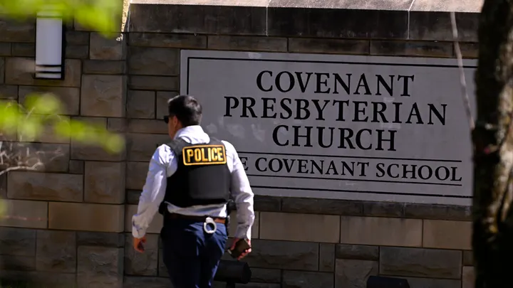 A police officer walks by an entrance to the Covenant School after a shooting in Nashville, Tennessee, on Monday, March 27, 2023. (AP Photo / John Amis)