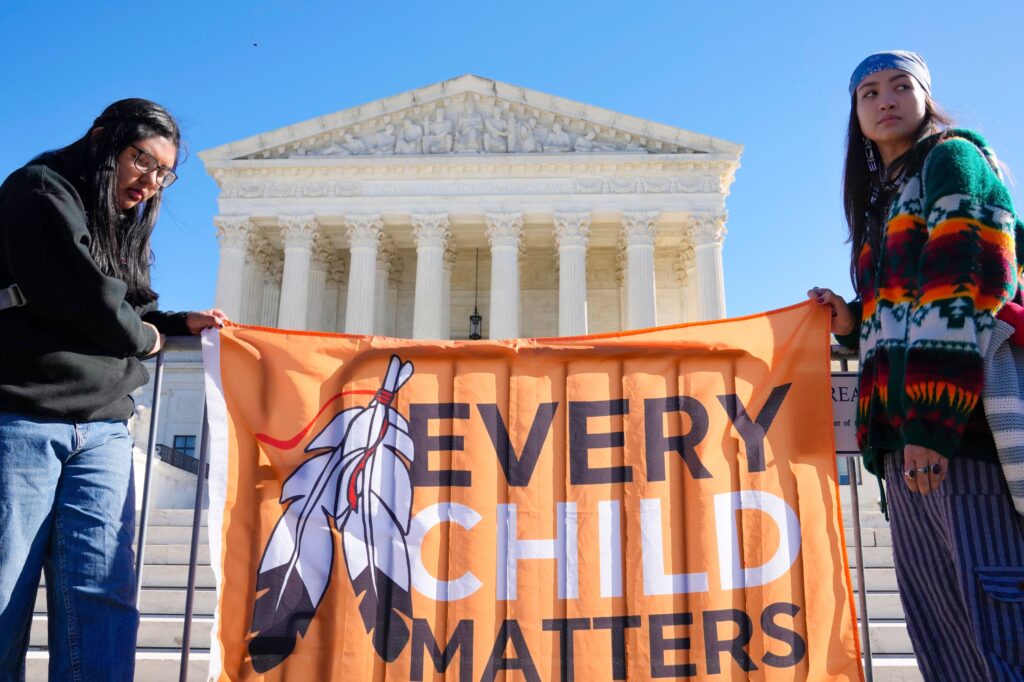 Demonstrators stand outside of the US Supreme Court on November 9, 2022 as the court heard arguments over the Indian Child Welfare Act.Mariam Zuhaib/AP